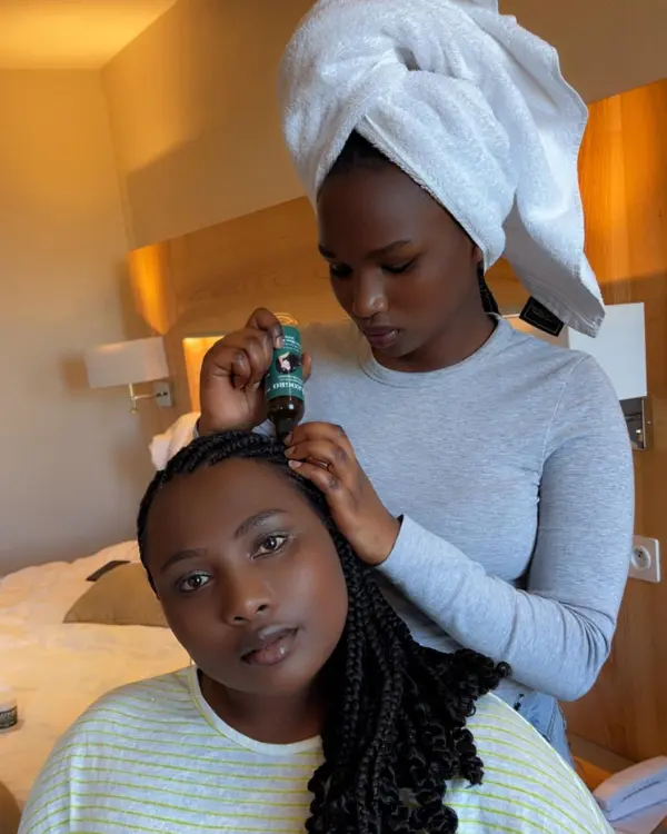 Applying Oleogro Hair Growth Oil to braided scalp